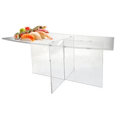 a table that has some sushi on it and is made out of acrylic