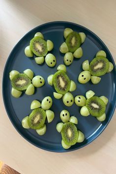 sliced kiwis in the shape of faces on a blue plate