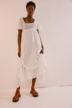 Romantic and ethereal, this sweet midi from our free-est collection is a true throw-on-and-go staple. **Fit:** Shapeless, babydoll-inspired silhouette **Features:** Square neckline, embroidered lace piecing, ruffle trimming throughout, back tie closure, flutte sleeves **Why We ❤ It:** Laid back with sporty sneakers or elevated with sleek platforms, this style has endless ways to wear. | Bring The Romance Midi Dress by free-est at Free People in White, Size: XS Sporty Sneakers, Trapeze Dress, People Dress, Embroidered Lace, Free People Dress, Clothes Gift, Square Neckline, Boho Outfits, New Outfits