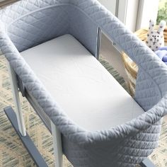 a baby crib that is next to a window