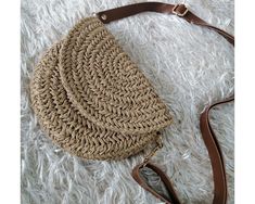 A great leather strap crossbody bag that can be used daily.  You can use it as a shoulder bag or as a handbag by removing the strap.  A great gift idea for your loved ones to use anytime.  This hand-knitted straw bag, in which you can easily put a few important personal items such as phone, wallet and keychain, can be completely personalized with your preferences.   How Does?   ✨ Bag size can be made larger or smaller.   ✨Knit or chain hanger can be made instead of leather strap.   ✨You can choose different colors that are not available in the options.   📩For all this, please contact me.   FEATURES:  ✅Knitted with paper yarn.   ✅It is combined with a adjustable leather strap ✅ Inside is lined with cotton fabric.  ✅Dimensions  8 inches × 6 inches Cleaning: Do not wash. Just clean with a we Leather Strap Bag, Knit Purse, Purse Gift, Boho Crochet, Bag Straps, Cross Body Handbags, Handmade Crochet, Happy Shopping, Straw Bag