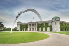 a large building with an arch in front of it