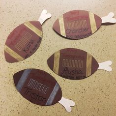 four pieces of paper cut out to look like footballs with words written on them