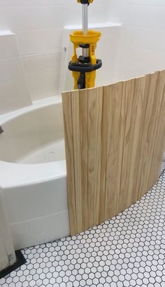 a white tub sitting next to a wooden wall