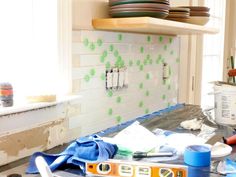 the kitchen counter is cluttered with dishes and utensils in preparation for painting