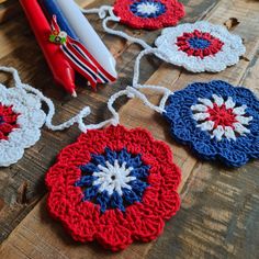 crocheted ornaments are laid out on a wooden table