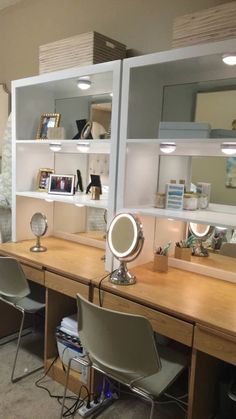 two desks with mirrors and lights on them