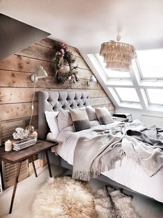 a bedroom with a large bed and wooden walls