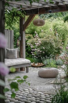 an outdoor area with rocks, plants and a bench