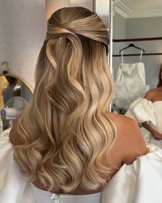 the back of a woman's head with blonde hair styled into a half - updo