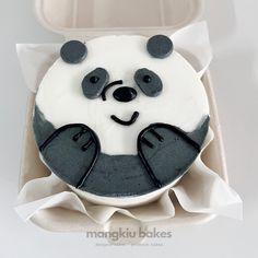 a panda bear cake in a box with white frosting