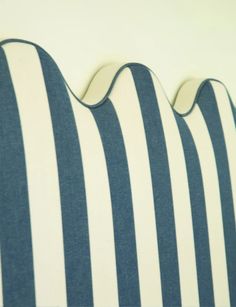 a close up of a blue and white striped pillow