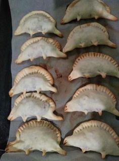 some kind of food that is sitting on a pan and ready to be cooked in the oven