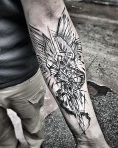 a man's arm with a tattoo on it that has geometric shapes and lines