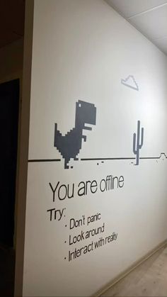 an office wall with the words, you are offline and a dinosaur on it