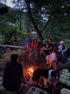 a group of people sitting around a campfire