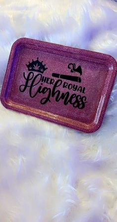 a purple tray with the words child royal agnes on it sitting on a fluffy white surface