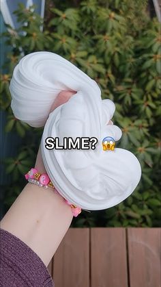 a woman's hand with a fake wig on it that says slime?