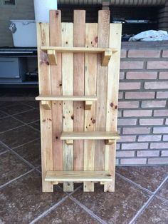 a wooden shelf sitting on top of a tiled floor