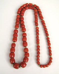 For Sale on 1stDibs - Barrel shaped Natural Mediterranean Red Coral beads that graduate in size. Gold Beads scattered between the coral beads. GIA Identification report No. Red Coral Beaded Necklaces With Spacer Beads, Red Coral Beaded Necklaces With Large Beads, Traditional Red Beaded Necklace For Formal Occasions, Red Rondelle Single Strand Beaded Necklace, Red Rondelle Beaded Necklace Single Strand, Red Rondelle Beaded Necklace, Single Strand, Red Coral Polished Beads For Jewelry Making, Traditional Red Rondelle Necklaces, Formal Red Coral Beaded Necklace