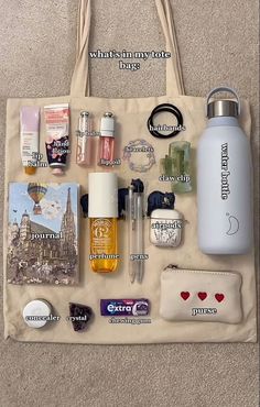 a tote bag filled with personal items on top of a carpeted floor next to a handbag