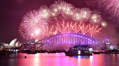 fireworks are lit up over the sydney harbour during new year's celebrations in australia