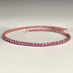 This exquisite handmade Natural Pink Sapphire Tennis Bracelet is the perfect accessory to sparkle on any occasion. Crafted in 14K/18K gold, this custom stacking bracelet showcases the September birthstone in a stunning design. Ideal as a Christmas gift, this one-of-a-kind piece of handmade jewelry is a must-have.𝐅𝐞𝐚𝐭𝐮𝐫𝐞𝐬:• 𝐌𝐚𝐝𝐞 𝐭𝐨 𝐎𝐫𝐝𝐞𝐫• 𝐌𝐞𝐭𝐚𝐥: 𝟏𝟒𝐊 | 𝟏𝟖𝐊• 𝐁𝐚𝐧𝐝 𝐂𝐨𝐥𝐨𝐫𝐬: Rose Gold, Yellow Gold & White Gold• 𝐂𝐮𝐬𝐭𝐨𝐦 𝐂𝐫𝐨𝐜𝐨𝐝𝐢𝐥𝐞 𝐋𝐨𝐜𝐤𝐒𝐭𝐨𝐧𝐞:• Rose Gold Bracelet With Prong Setting For Gift, Flexible Rose Gold Tennis Bangle Bracelet, Flexible Rose Gold Bracelet In Fine Jewelry Style, Flexible Rose Gold Bracelet Fine Jewelry, Elegant Pink Stackable Bracelets, Rose Gold Flexible Tennis Bracelet For Anniversary, Rose Gold Stackable Diamond Bracelet, Rose Gold Tennis Bracelet As Gift, Formal Stackable Rose Gold Tennis Bracelet