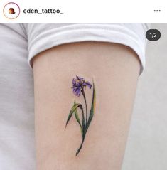 a purple flower tattoo on the left thigh