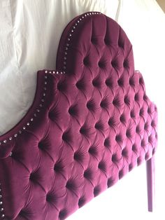 an upholstered headboard with pearls on it