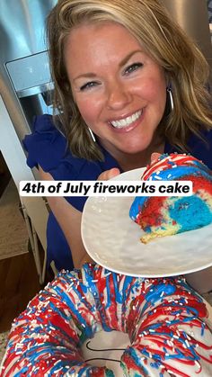 a woman holding a piece of cake with red, white and blue frosting on it