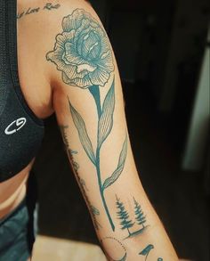 a woman with a flower tattoo on her arm