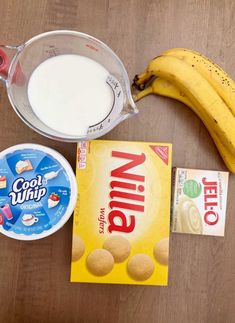 ingredients to make an ice cream smoothie laid out on a wooden table with bananas and yogurt