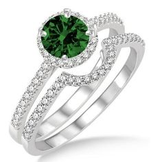 a green and white diamond ring set on top of each other with two matching bands