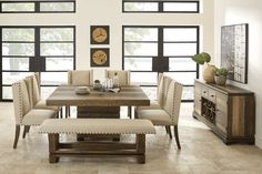 a dining room table with chairs and bench in front of large windows, next to an entertainment center