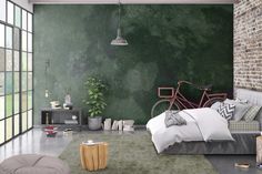 a bedroom with brick walls and flooring has a bike on the wall next to the bed