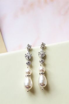 Vintage style  earrings  with Swarovski pearls Colour: rhodium-silver tone/clear/light ivory. Measurements: approx 4.3 cm including studs (tiny and delicate earrings).  Materials:  rhodium components, zircon crystals, Swarovski white/lt.ivory pearls . Stud earrings. Great for wedding or other celebration. Same earrings in rose gold available here: https://www.etsy.com/uk/listing/613966913/on-sale-rose-gold-bridal-earrings-art?ref=shop_home_active_52 MORE SAME STYLE: https://www.etsy.com/uk/shop/ Classic Crystal Bridal Earrings With Pearl Drop, Elegant Silver Dangle Pearl Earrings, Silver Dangle Pearl Earrings With Elegant Design, Silver Pearl Wedding Earrings, Wedding Pearl Chandelier Earrings In Silver, Wedding Chandelier Earrings In Silver With Pearls, Silver Pearl Chandelier Earrings For Wedding, Formal Silver Chandelier Earrings With Pearl Drop, Silver Chandelier Earrings With Pearl Drop For Formal Occasions