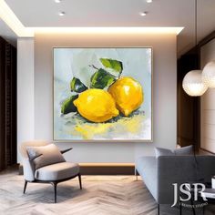 a living room with a couch, chair and painting on the wall that has two lemons in it