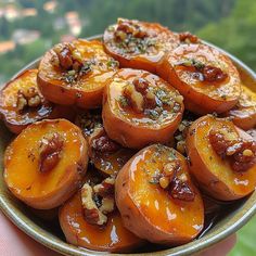 a bowl filled with lots of sliced up peaches on top of a wooden table