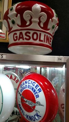 two red and white gas signs are on display