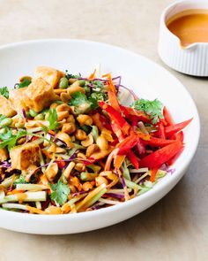 a white bowl filled with salad and tofu