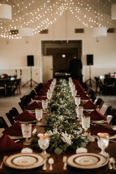 the long table is set with place settings for dinner guests to sit down and eat