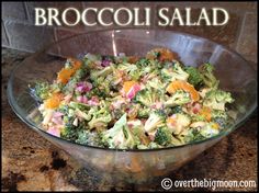 broccoli salad in a glass bowl with the words broccoli salad above it