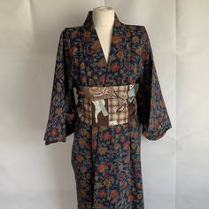 Vintage Japanese kimono. Dark blue with red and ochre floral design, Fabric unknown, but strong, good quality and hard wearing. Straight and hand stitched. Armpit to armpit 23 inches 59 cm, back length 61 inches 154 cm. cotton lined back yoke and seat. Very Good vintage condition.  As with all kimono, hang up to air, or specialist clean, generally should not be washed, although some can be successfully hand washed. All the kimono that I sell have been steamed. Any marks are minor, and historic! Vintage Multicolor Kimono, Vintage Floral Print Kimono, Blue Long Sleeve Kimono With Floral Print, Blue Floral Print Long Sleeve Kimono, Blue Long Sleeve Vintage Kimono, Traditional Long Blue Kimono, Traditional Floral Print Kimono For Tea Ceremony, Traditional Blue Long Sleeve Kimono, Floral Print Kimono For Tea Ceremony