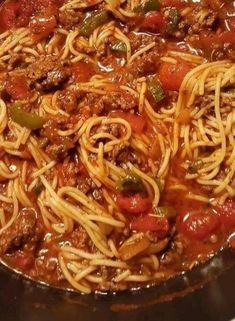 a skillet filled with spaghetti and meat