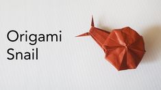 the origami snail is made from red paper