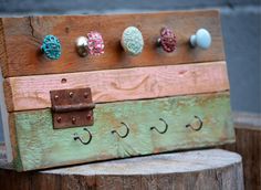 a wooden sign with six knobs on it sitting on top of a tree stump