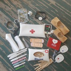 an assortment of medical items laid out on a wooden table with scissors, gloves and other accessories