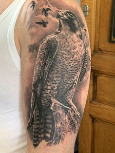 a man's arm with an eagle tattoo on it