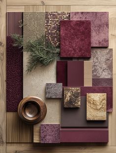 a wooden table topped with lots of different types of tiles and rugs on top of it