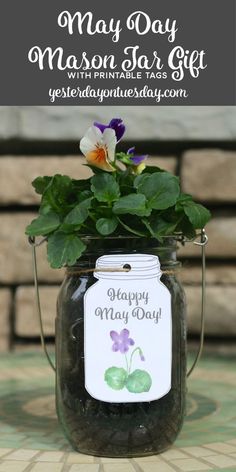 a mason jar with flowers in it and the words happy mother's day written on it